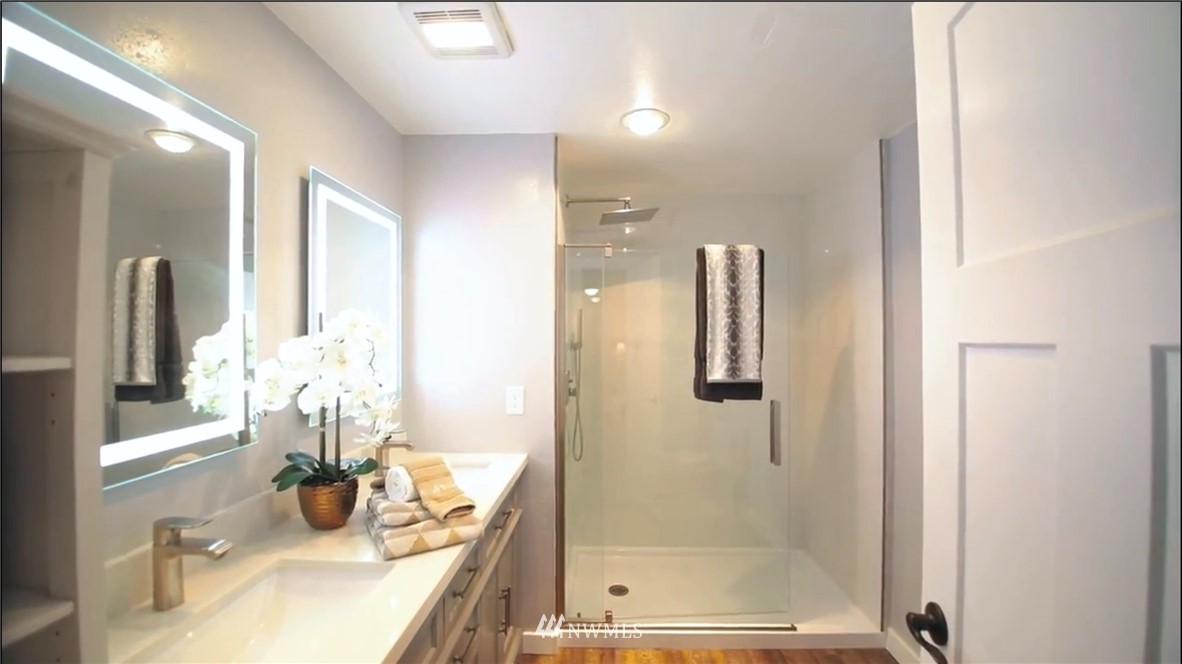 908 North 33rd Street Renton, WA 98056 - Photo 16 of 22 a bathroom with a granite countertop sink a mirror and shower