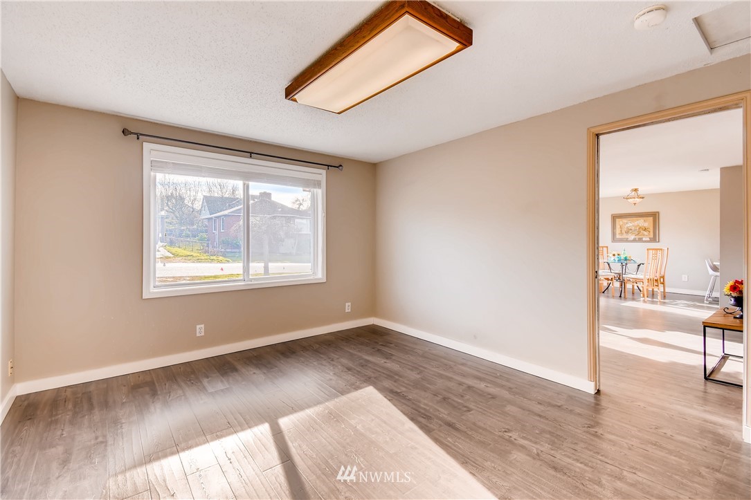 908 North 33rd Street Renton, WA 98056 - Photo 9 of 22 a view of an empty room with wooden floor and a window