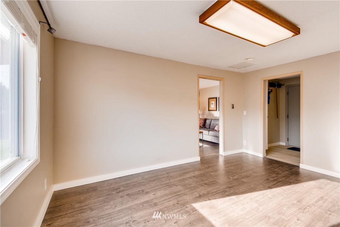 908 North 33rd Street Renton, WA 98056 - Photo 10 of 22 a view of a hallway with wooden floor and a living room