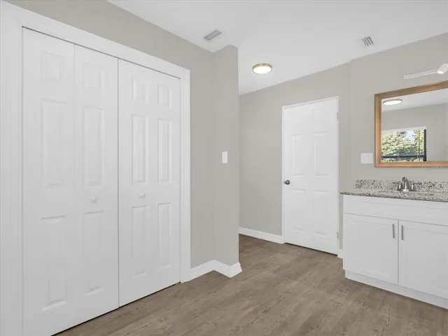 an empty room with a bathroom and mirror