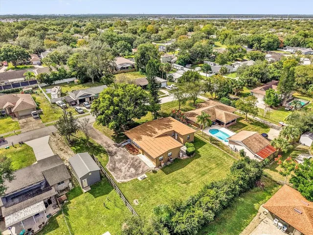 an aerial view of residential houses with yard