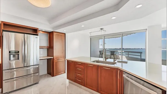 a kitchen with kitchen island a sink stove and refrigerator