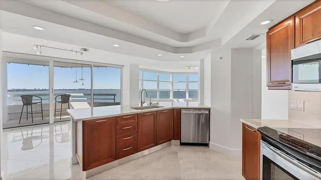a kitchen with granite countertop a sink and a cabinets