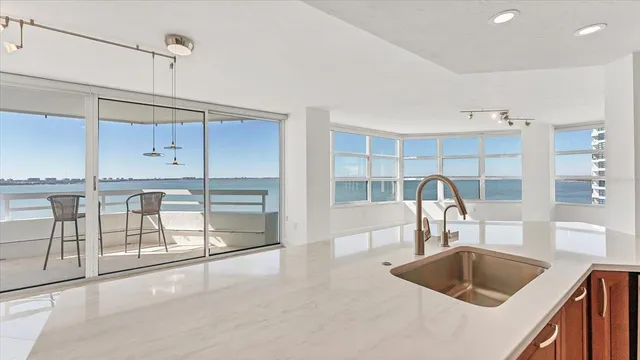 a view of an empty room with wooden floor and windows