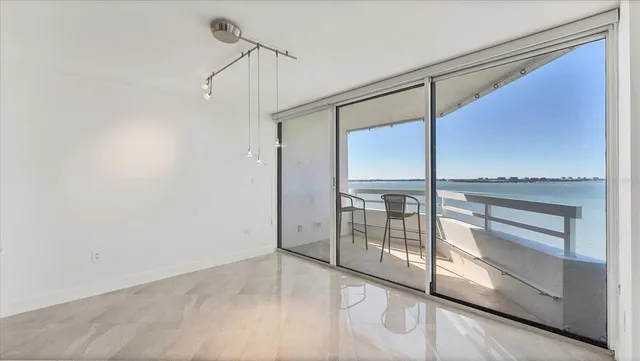 a living room with furniture and a floor to ceiling window