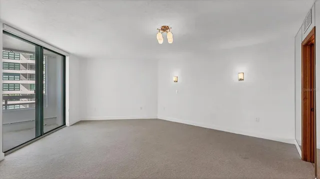 a view of an empty room with a bathroom