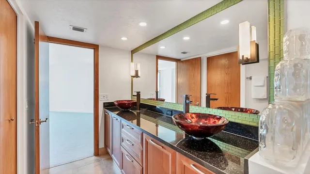 a bathroom with a glass shower door