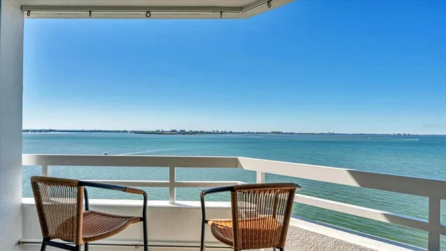 a view of a balcony with chair and table