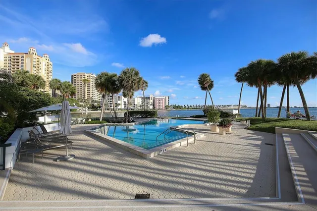 a view of swimming pool with a table and chairs