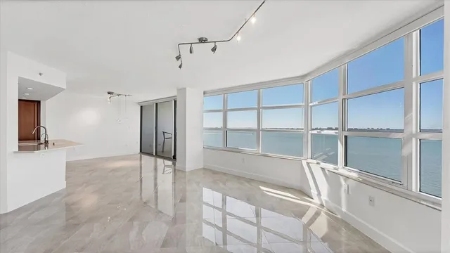a view of a kitchen with a sink and a refrigerator