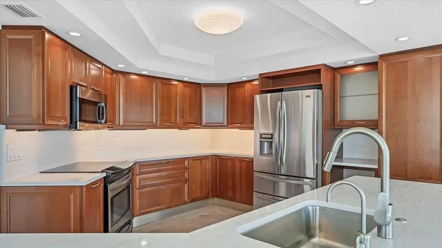 a kitchen with stainless steel appliances a refrigerator and sink
