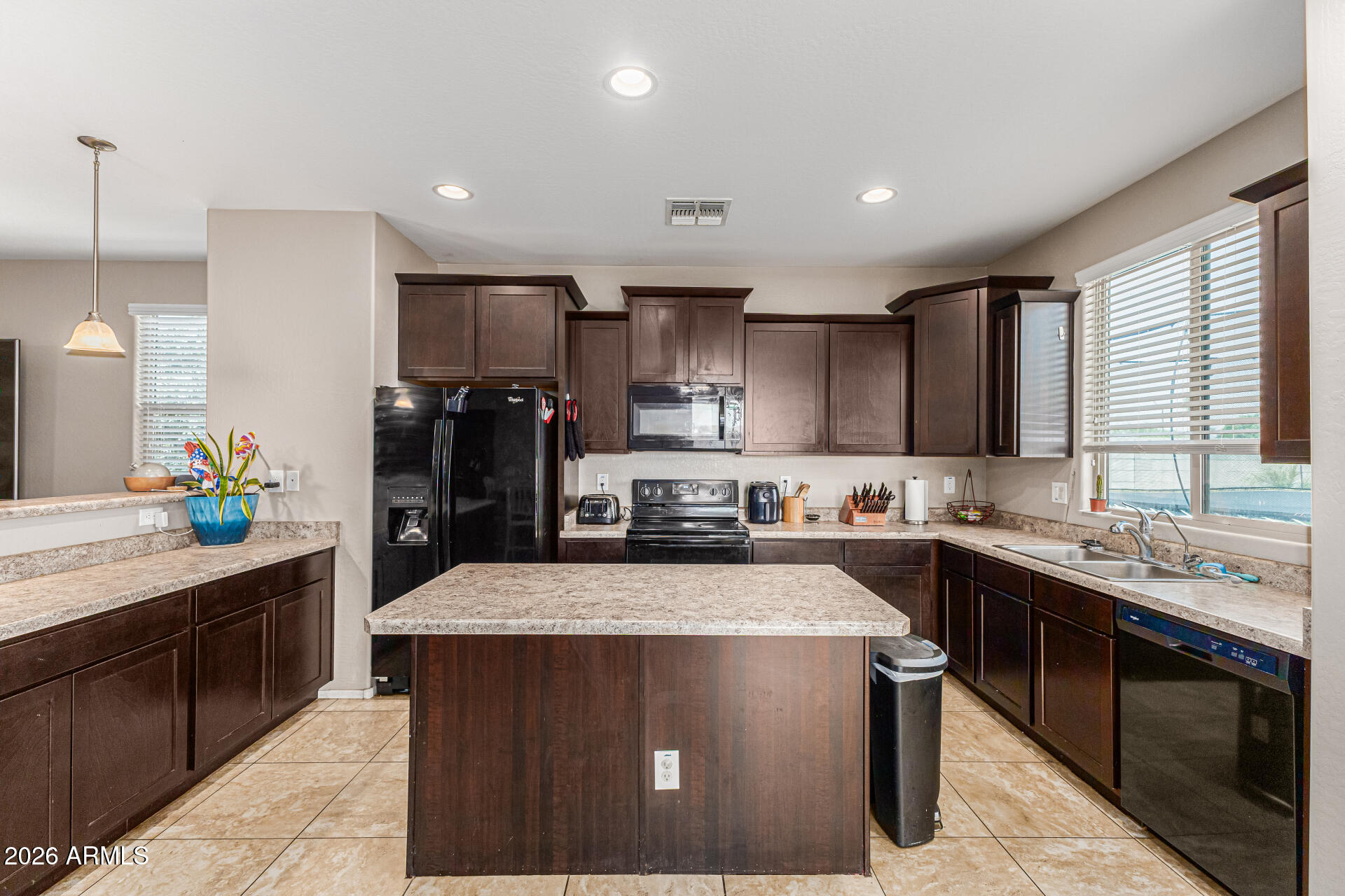 12214 West Del Rio Lane Avondale, AZ 85323 - Photo 11 of 32 a kitchen with a sink a stove and cabinets