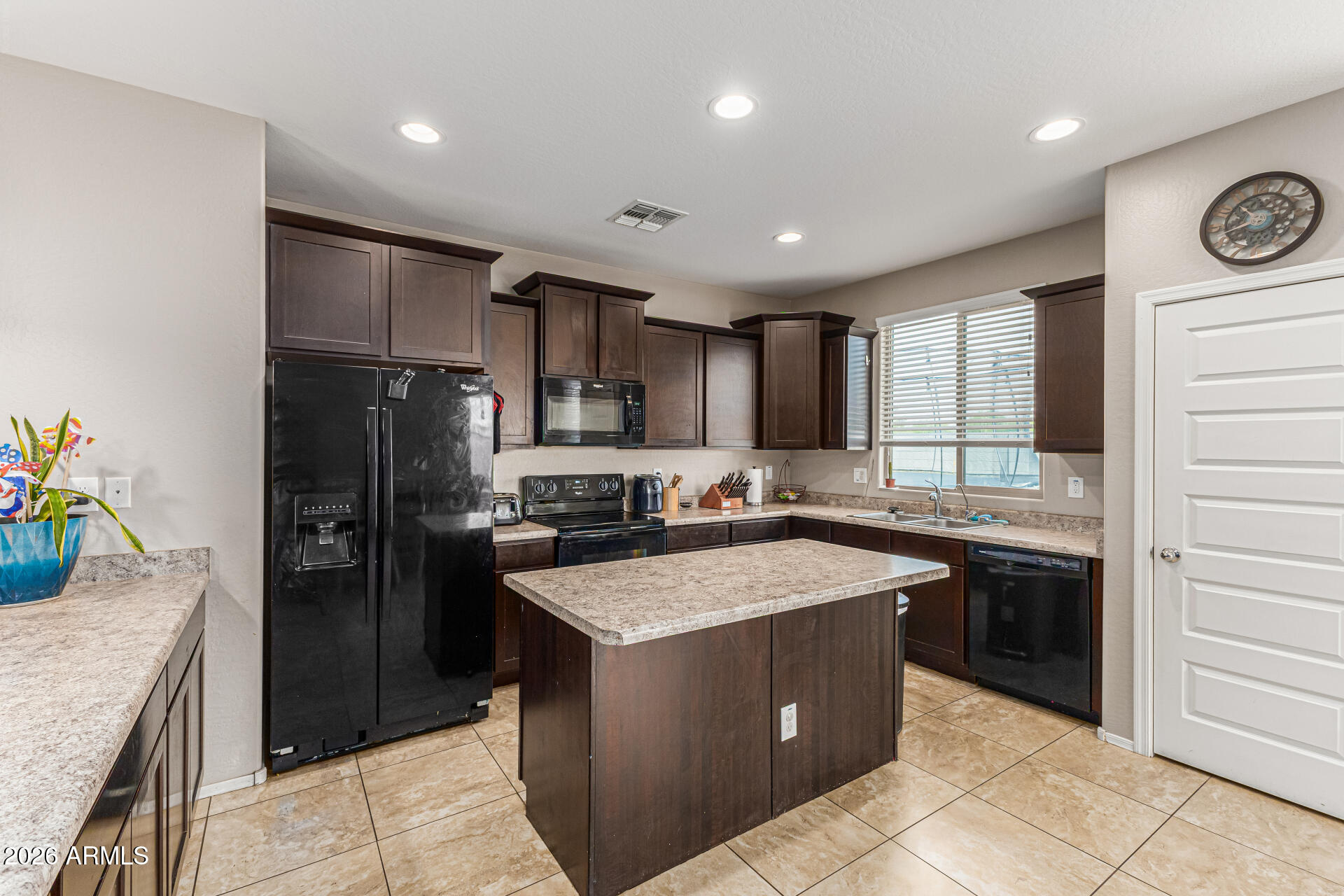 12214 West Del Rio Lane Avondale, AZ 85323 - Photo 12 of 32 a kitchen with a refrigerator a sink and dishwasher