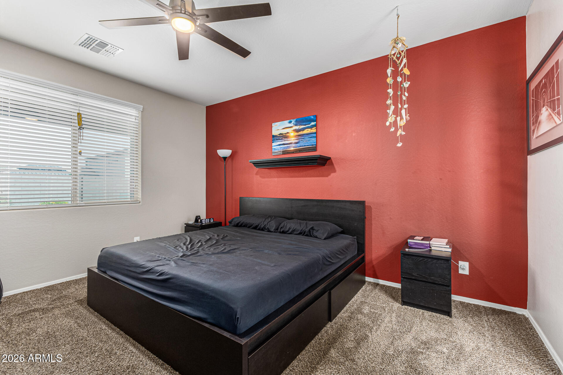 12214 West Del Rio Lane Avondale, AZ 85323 - Photo 13 of 32 a bedroom with a bed and a chandelier