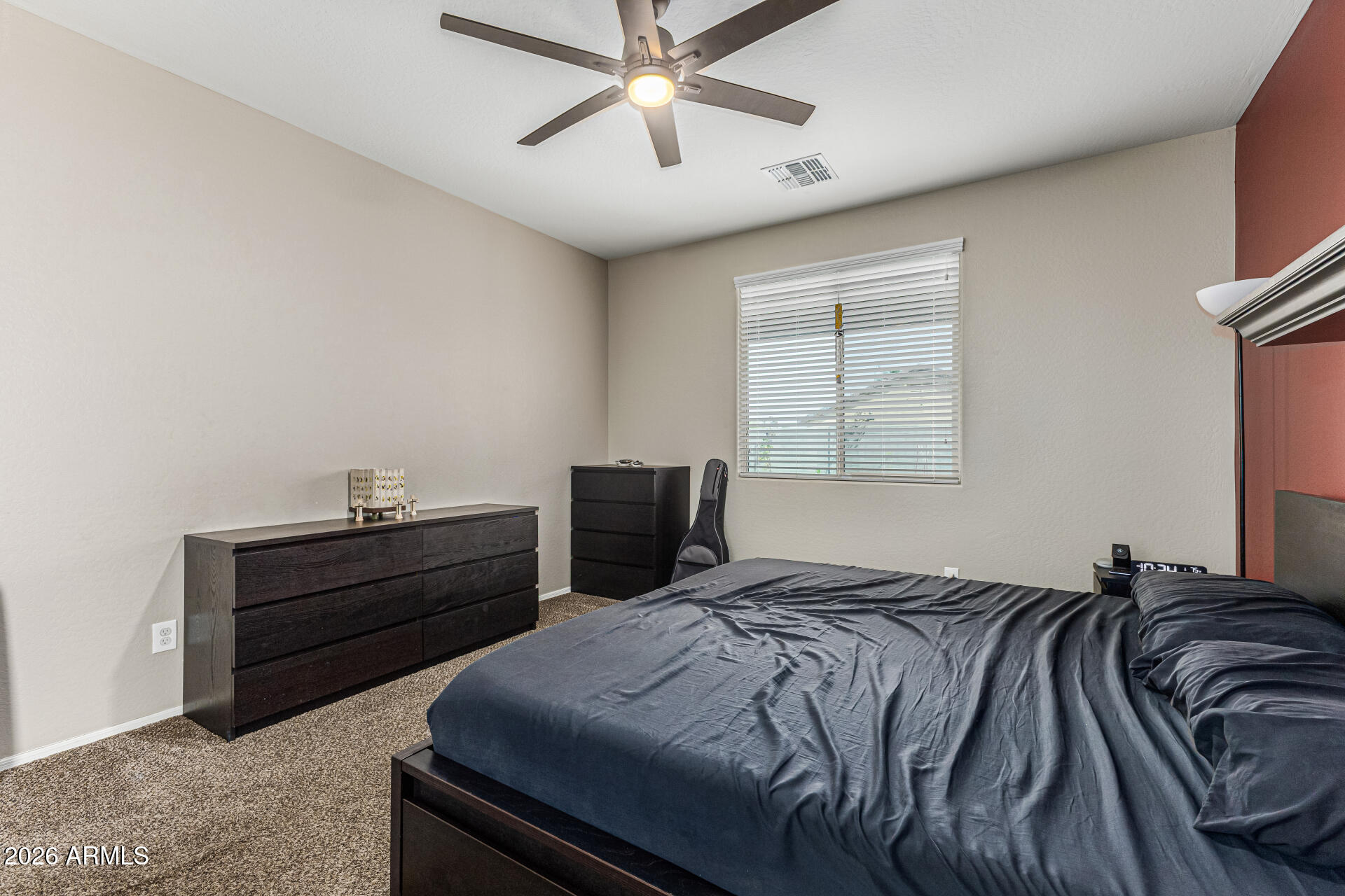 12214 West Del Rio Lane Avondale, AZ 85323 - Photo 14 of 32 a bed room with a bed and a window