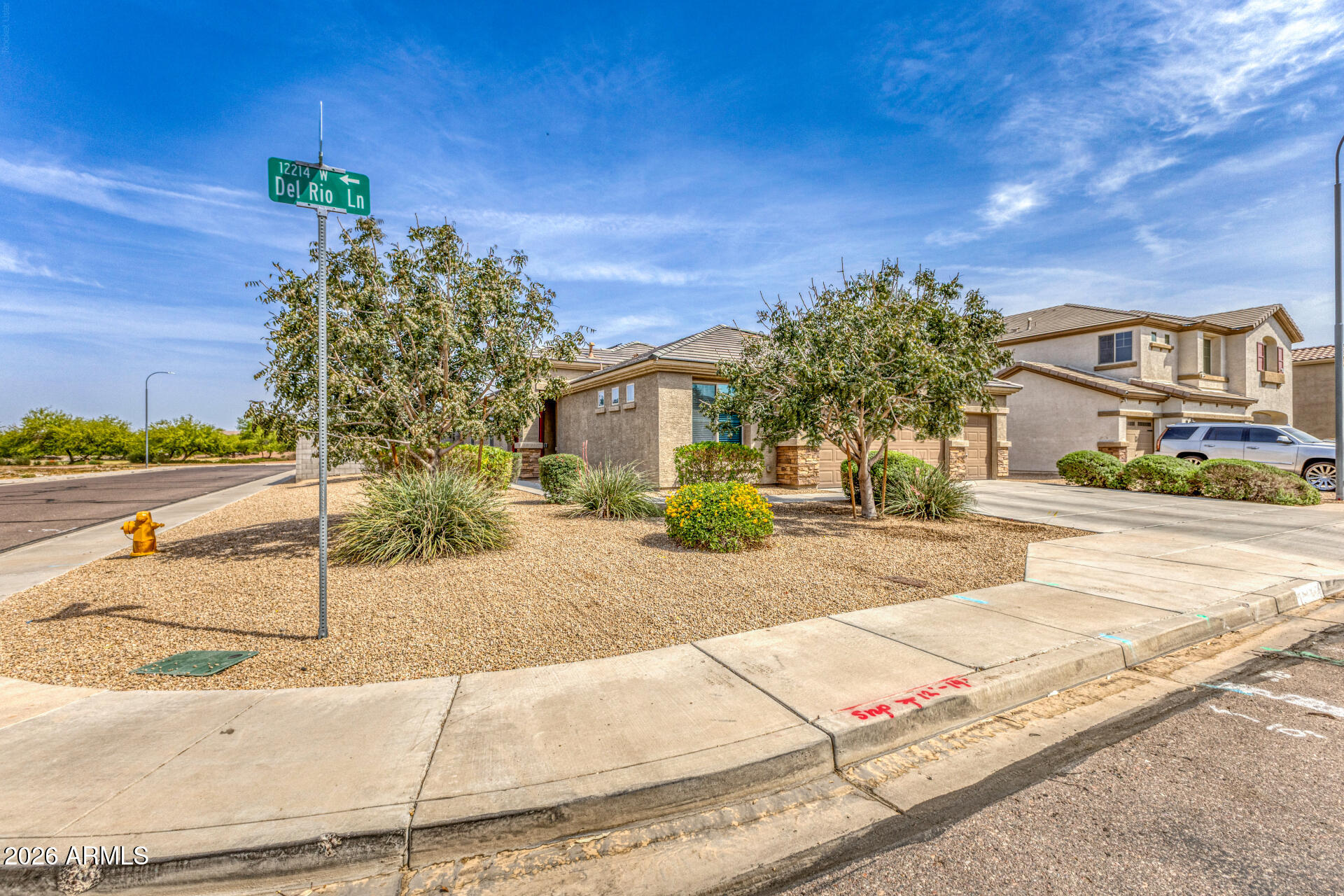 12214 West Del Rio Lane Avondale, AZ 85323 - Photo 2 of 32 a view of a street with house on the roadside