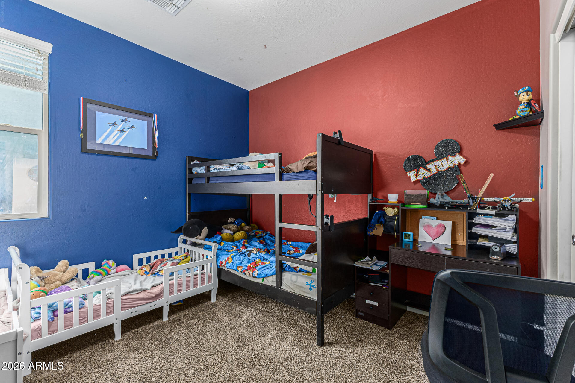 12214 West Del Rio Lane Avondale, AZ 85323 - Photo 21 of 32 a bedroom with a bed and a tv in it