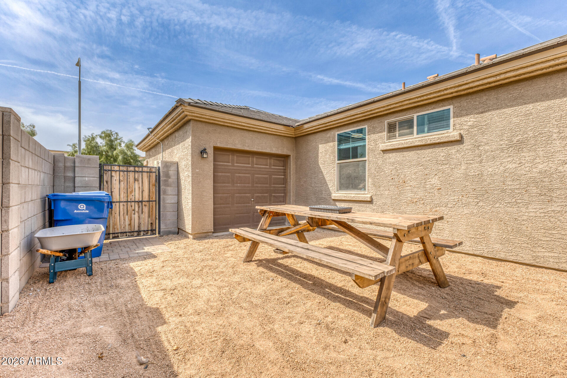 12214 West Del Rio Lane Avondale, AZ 85323 - Photo 27 of 32 a backyard of a house with barbeque oven table and chairs