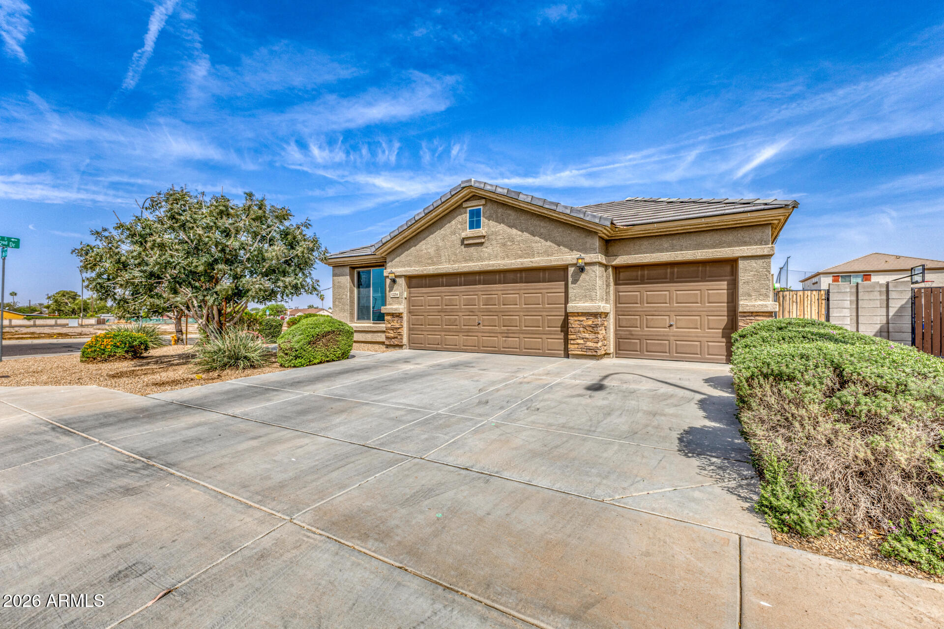 12214 West Del Rio Lane Avondale, AZ 85323 - Photo 3 of 32 a front view of a house with a yard and garage