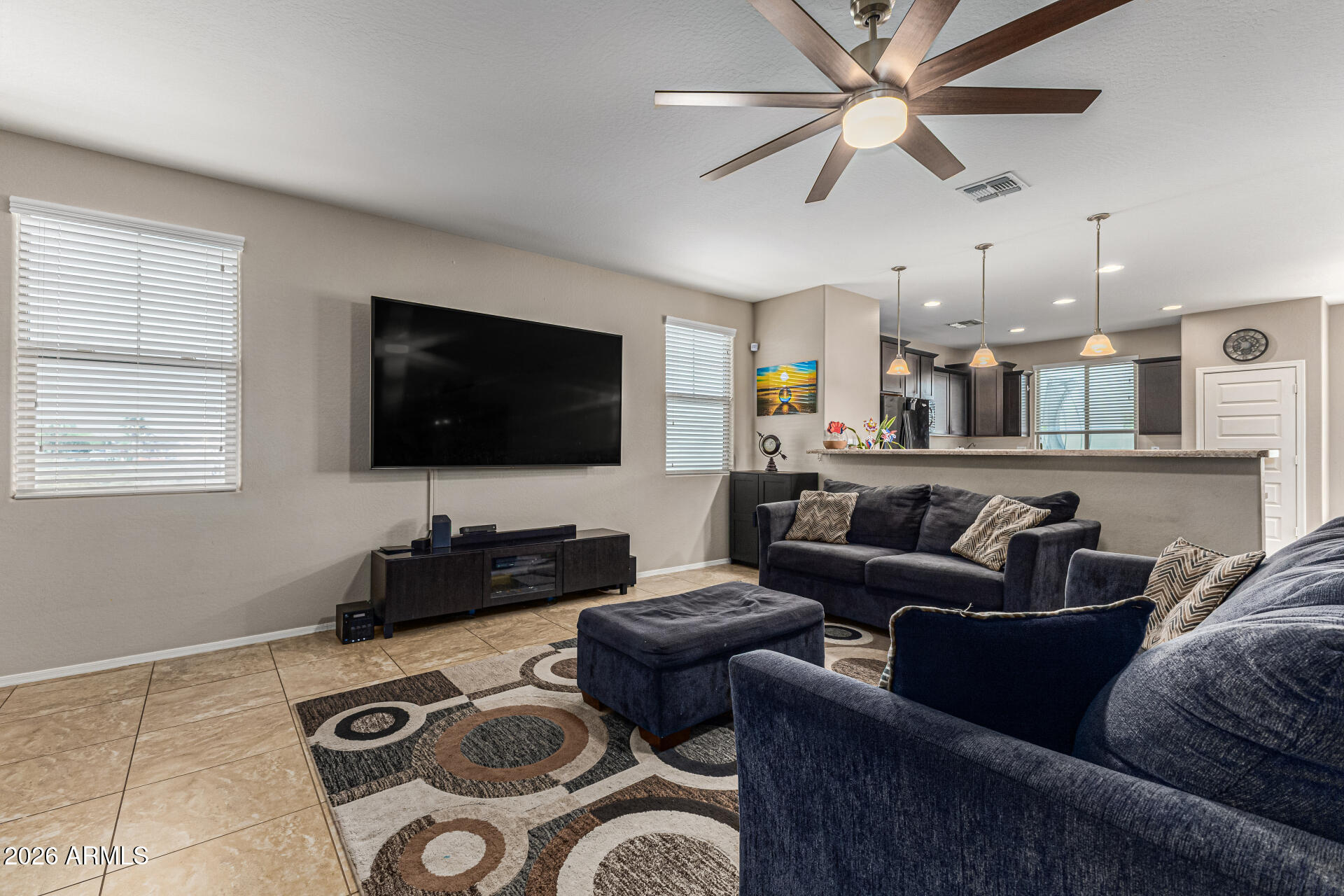 12214 West Del Rio Lane Avondale, AZ 85323 - Photo 5 of 32 a living room with furniture and a flat screen tv