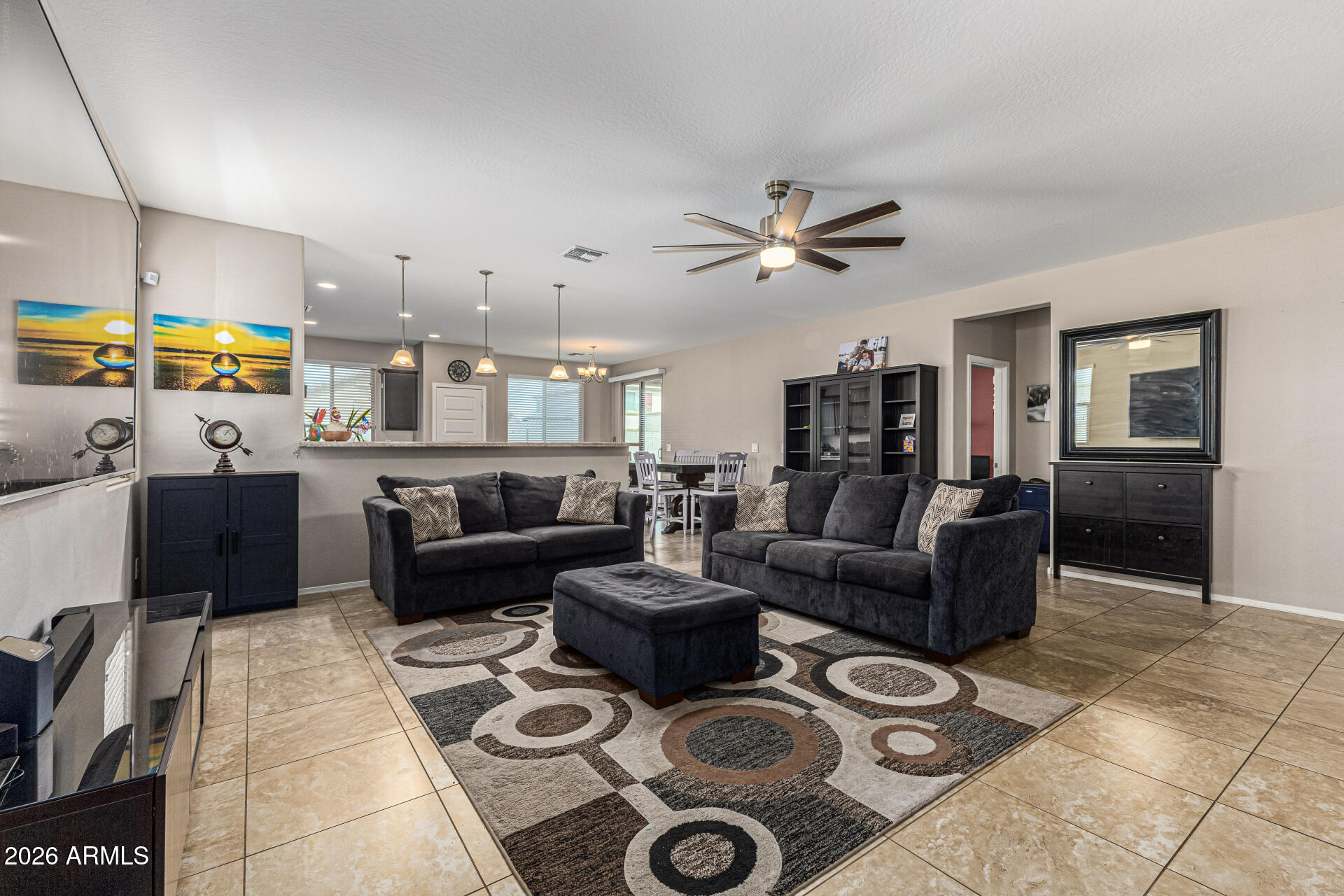 12214 West Del Rio Lane Avondale, AZ 85323 - Photo 6 of 32 a living room with furniture and a chandelier