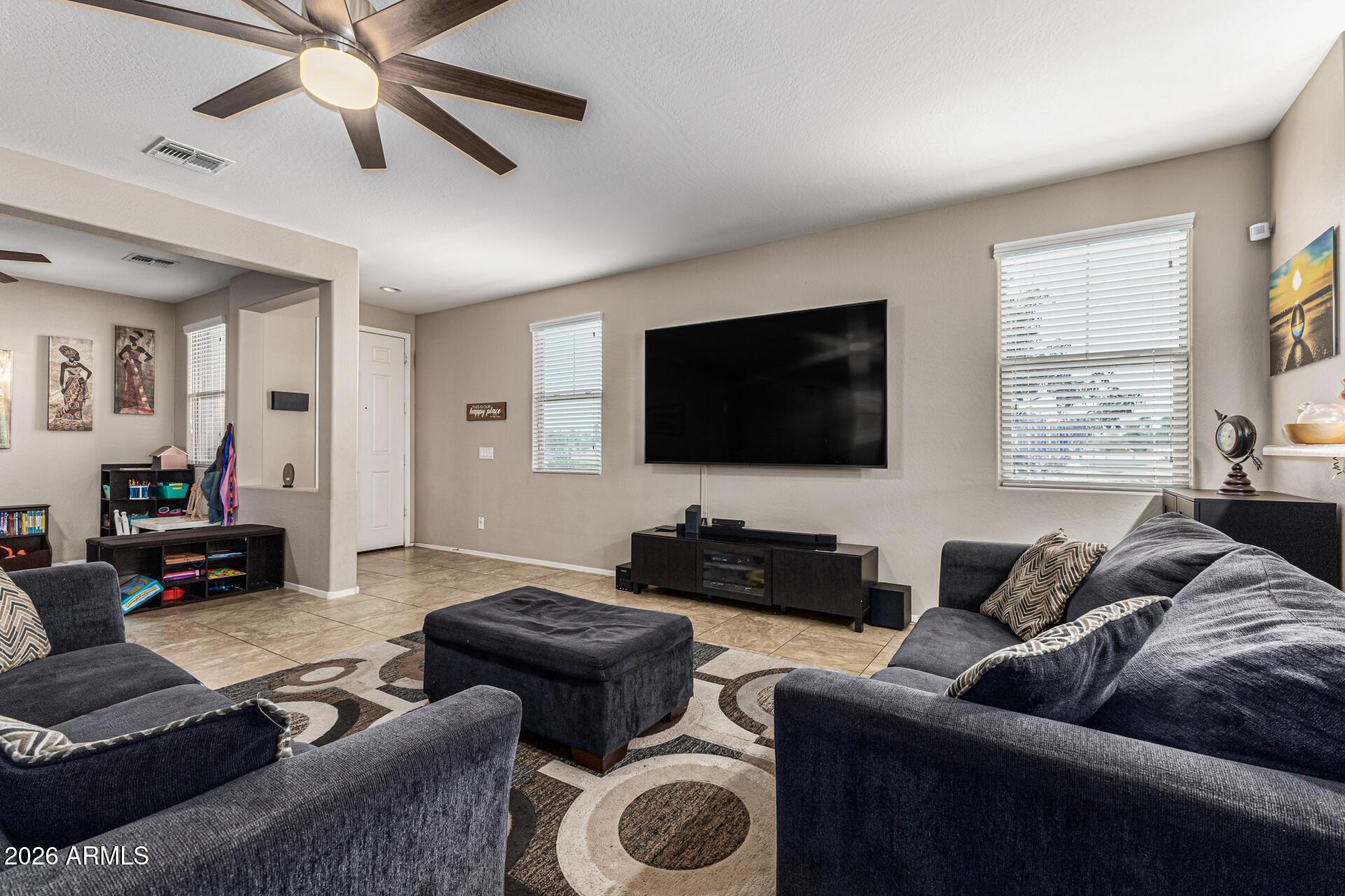 12214 West Del Rio Lane Avondale, AZ 85323 - Photo 7 of 32 a living room with furniture and a flat screen tv