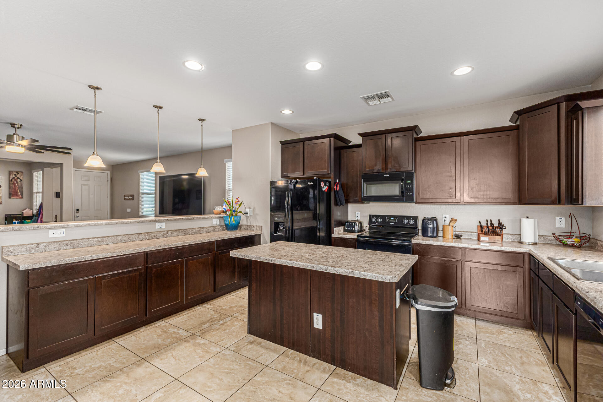 12214 West Del Rio Lane Avondale, AZ 85323 - Photo 10 of 32 a kitchen with stainless steel appliances granite countertop a sink a stove and a refrigerator