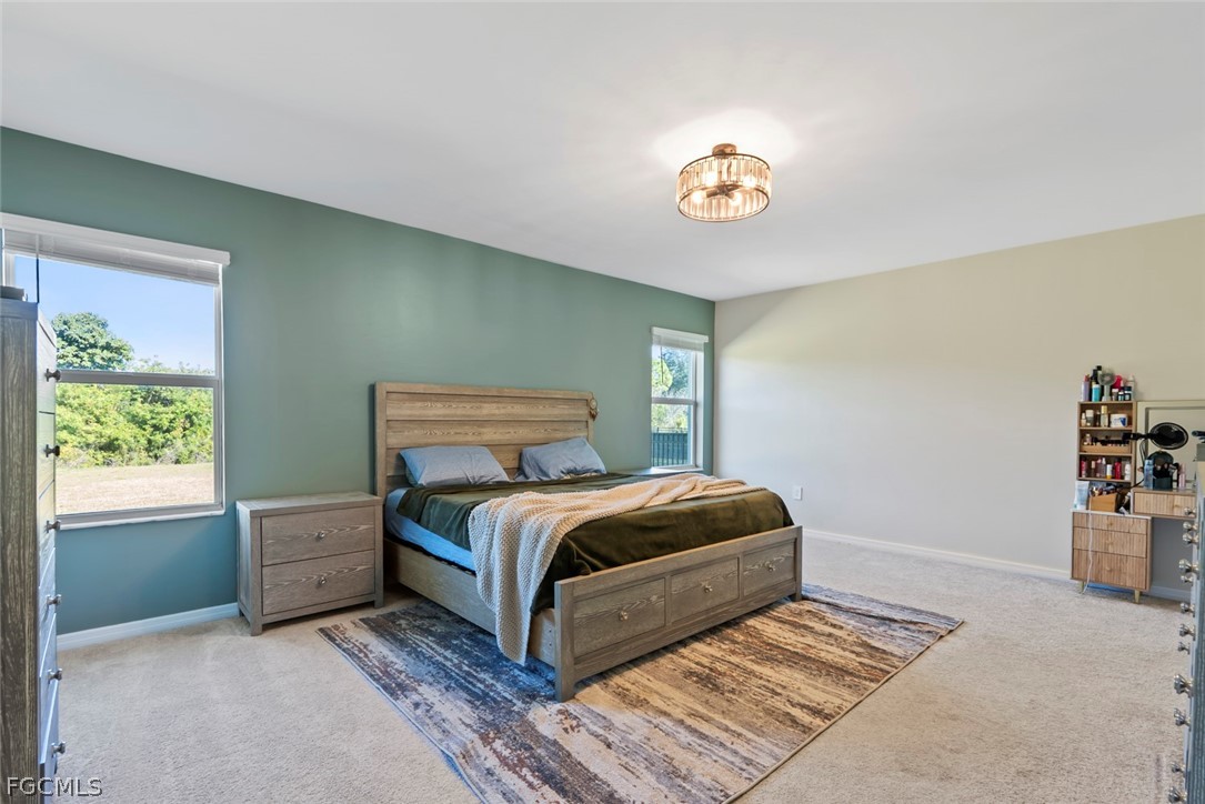 19972 Green Pasture Road Lehigh Acres, FL 33974 - Photo 15 of 48 a bedroom with a bed and a window