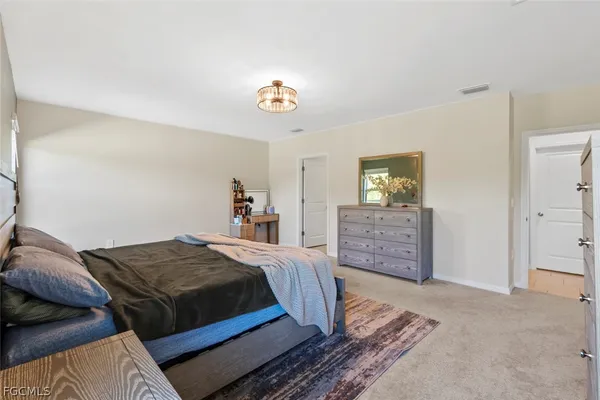 a bedroom with bed and window