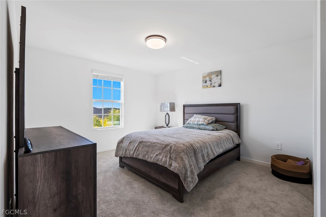 19972 Green Pasture Road Lehigh Acres, FL 33974 - Photo 23 of 48 a bedroom with a bed and a window