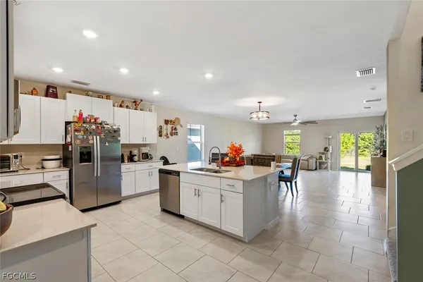 a kitchen with stainless steel appliances granite countertop a sink and cabinets