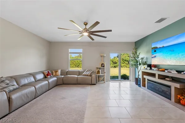 a view of kitchen with kitchen island stainless steel appliances refrigerator stove a dining table chairs and a stove