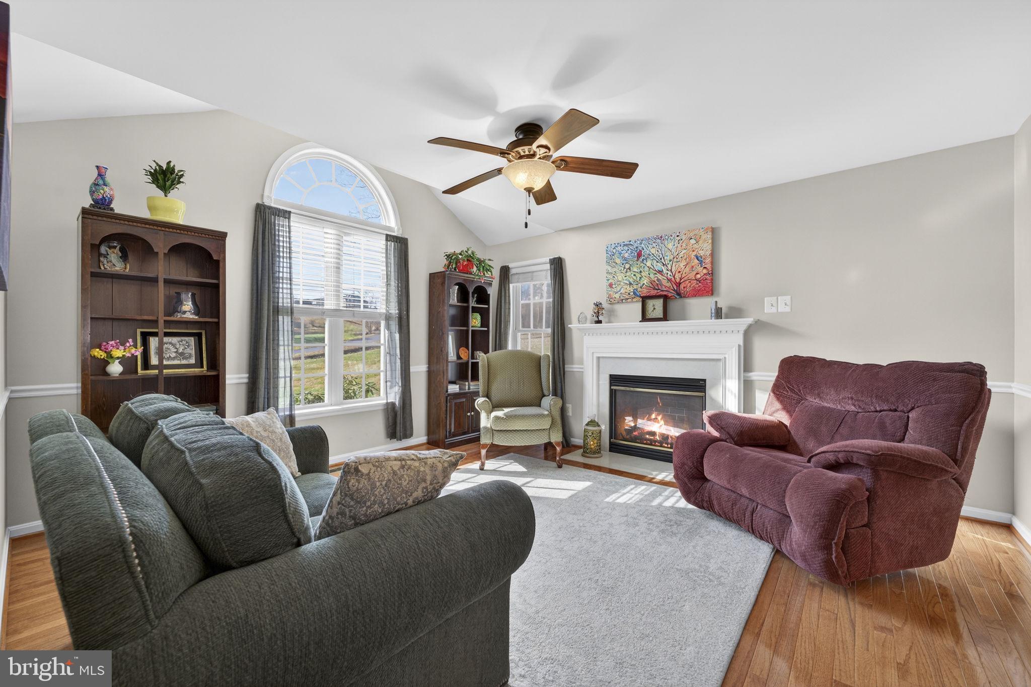 12376 Robin Road Culpeper, VA 22701 - Photo 13 of 70 a living room with furniture a fireplace and a large window