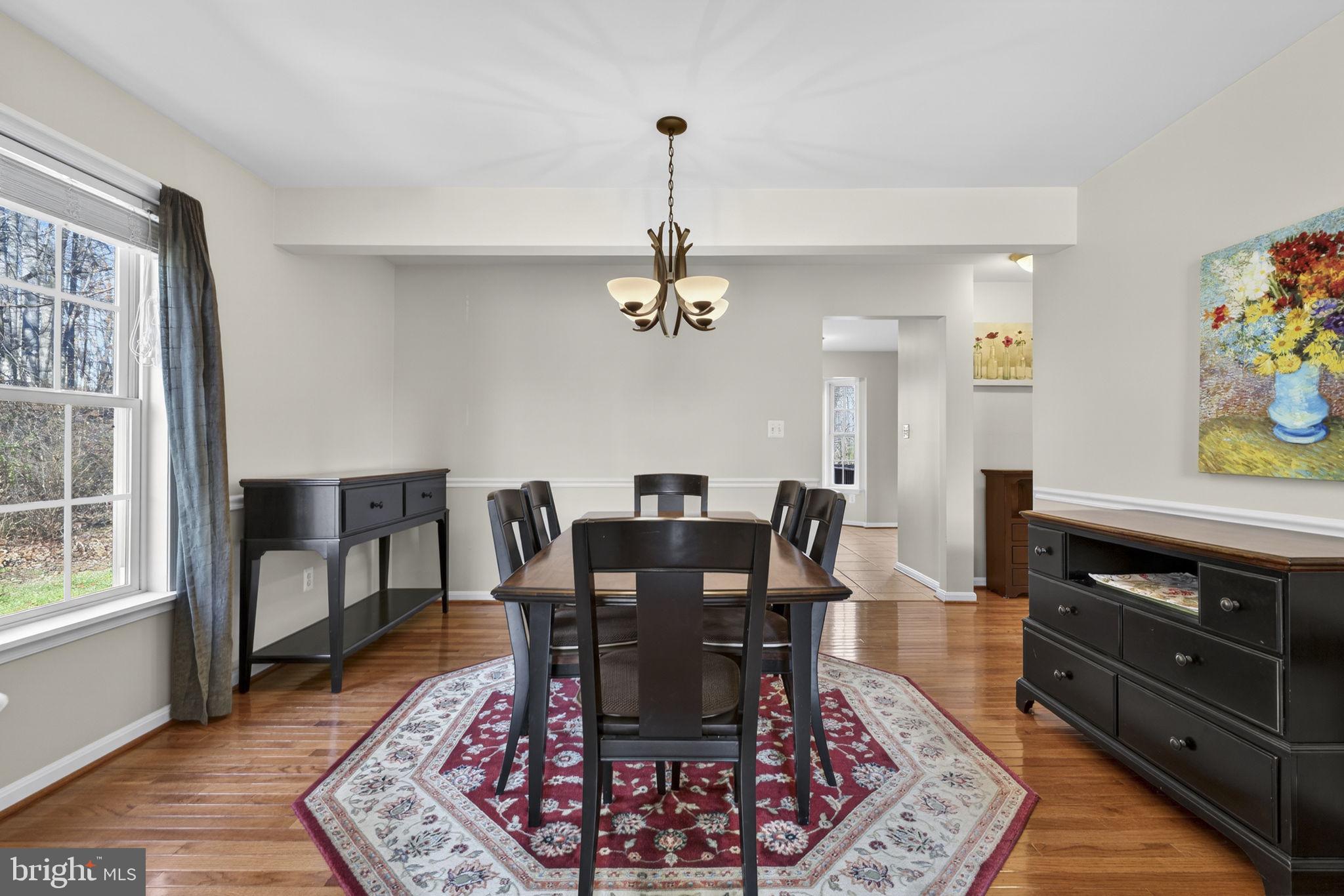 12376 Robin Road Culpeper, VA 22701 - Photo 17 of 70 a dining room with furniture a rug and wooden floor
