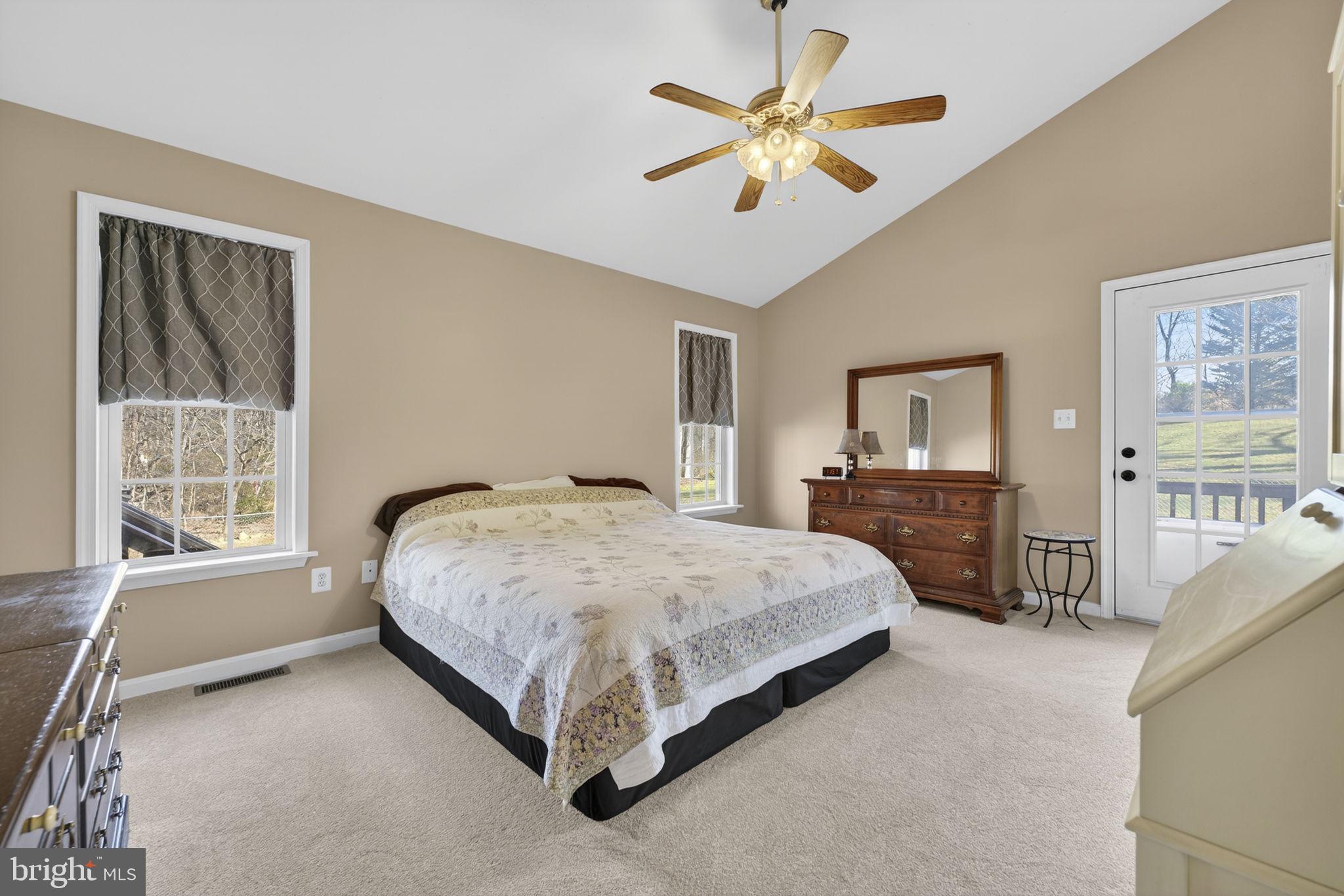 12376 Robin Road Culpeper, VA 22701 - Photo 23 of 70 a spacious bedroom with a large bed and a chandelier