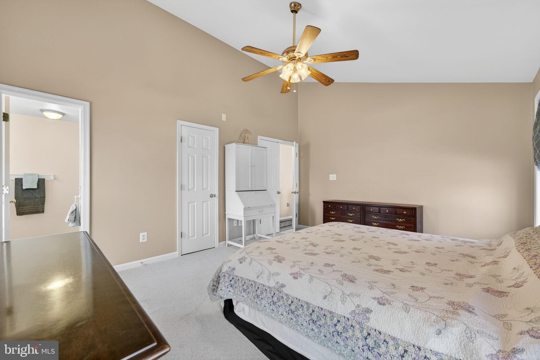 12376 Robin Road Culpeper, VA 22701 - Photo 25 of 70 a bedroom with a large bed and a chandelier