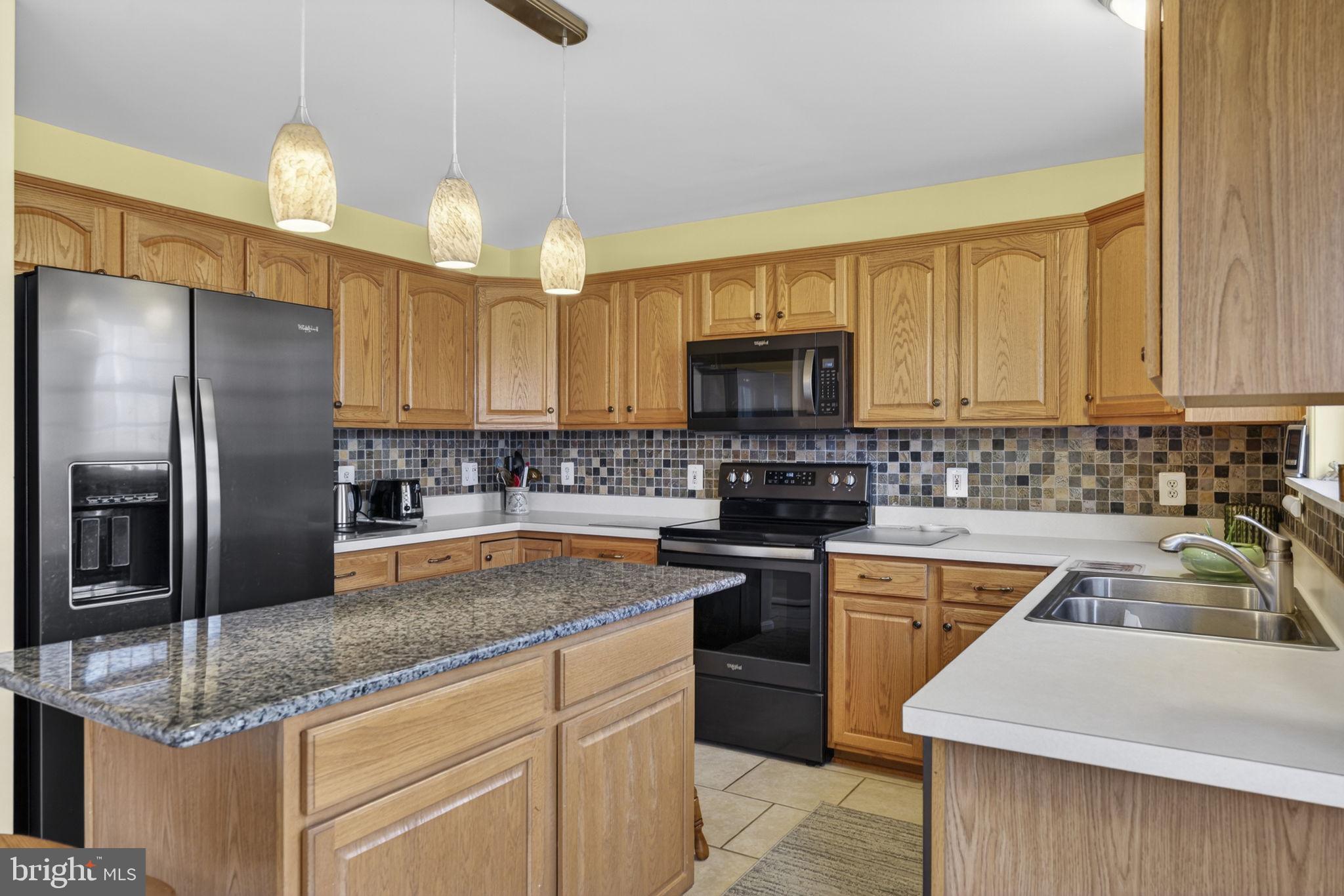 12376 Robin Road Culpeper, VA 22701 - Photo 34 of 70 a kitchen with a sink a center island cabinets and stainless steel appliances