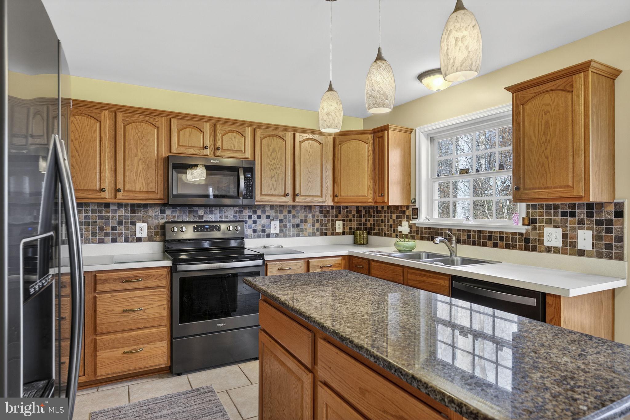 12376 Robin Road Culpeper, VA 22701 - Photo 35 of 70 a kitchen with stainless steel appliances granite countertop a sink stove microwave and cabinets