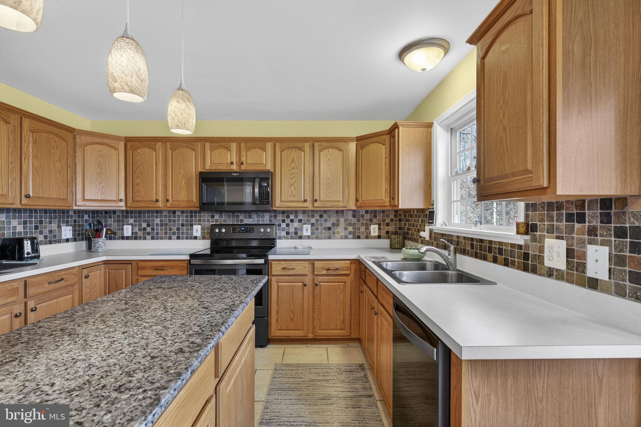 12376 Robin Road Culpeper, VA 22701 - Photo 39 of 70 a kitchen with a sink stove top oven and microwave