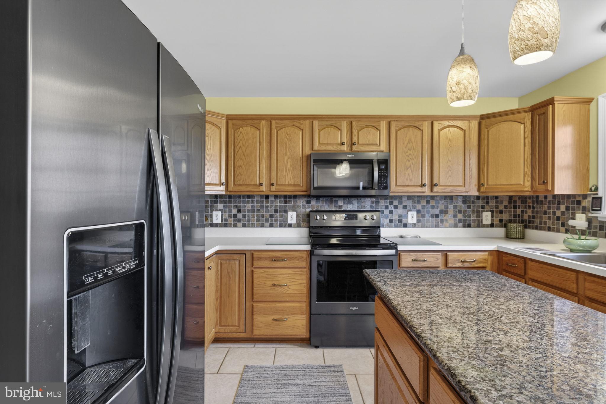 12376 Robin Road Culpeper, VA 22701 - Photo 40 of 70 a kitchen with stainless steel appliances granite countertop a sink stove and refrigerator
