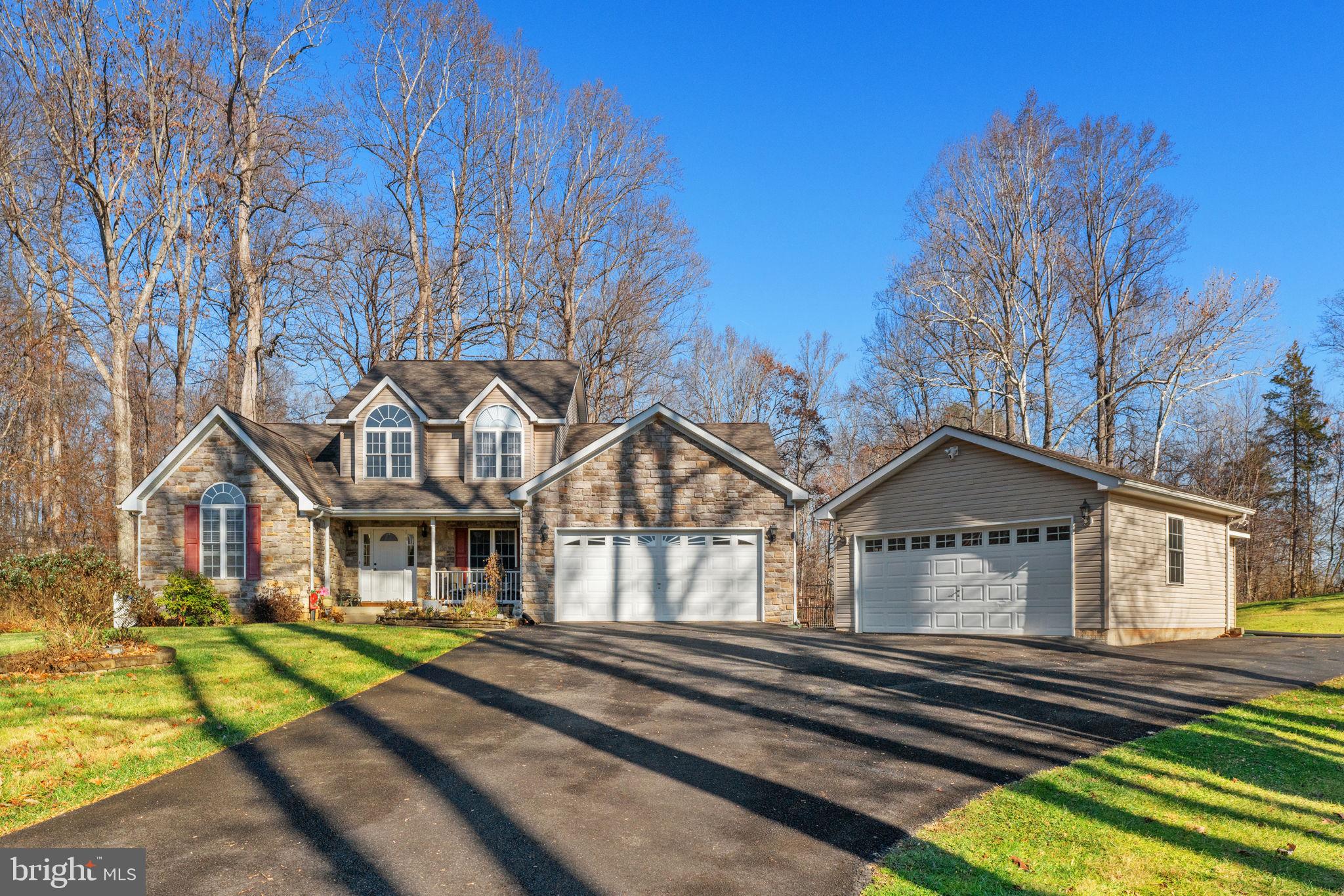 12376 Robin Road Culpeper, VA 22701 - Photo 4 of 70 a view of a big house with large windows and a small yard