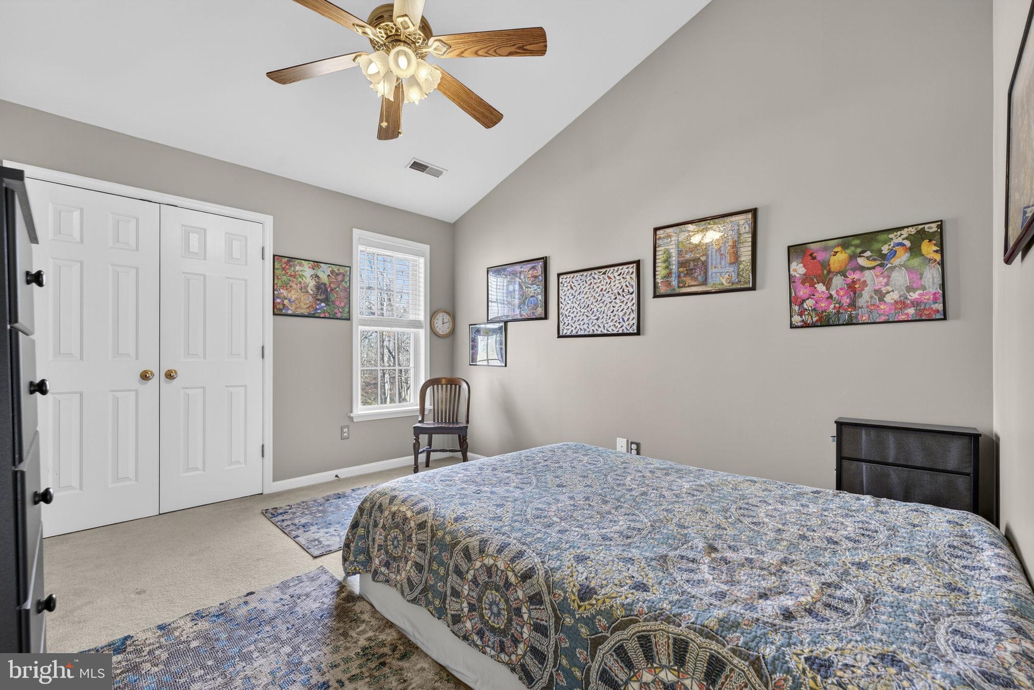 12376 Robin Road Culpeper, VA 22701 - Photo 45 of 70 a bedroom with a bed and a chandelier