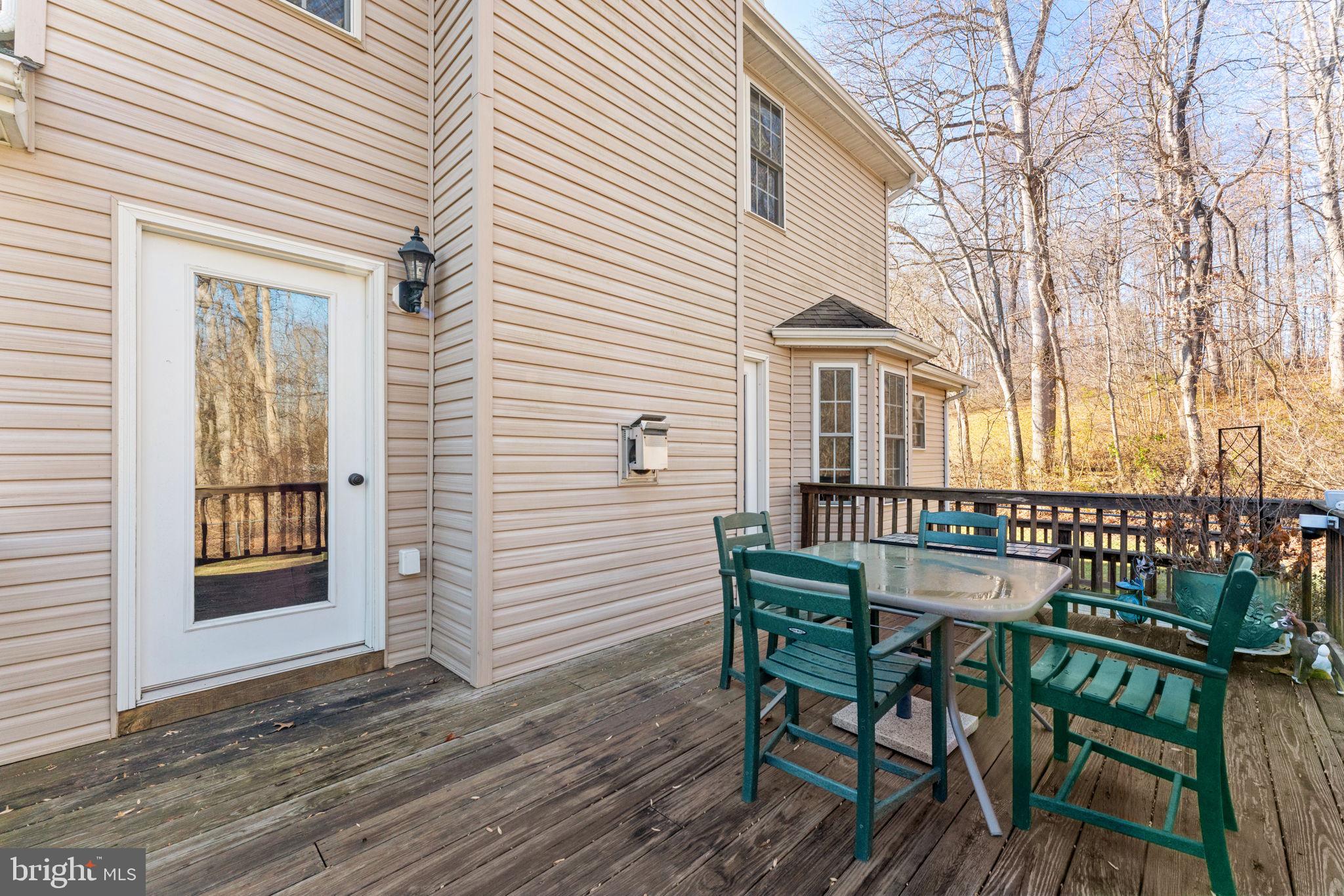 12376 Robin Road Culpeper, VA 22701 - Photo 57 of 70 a view of a house with wooden deck and furniture
