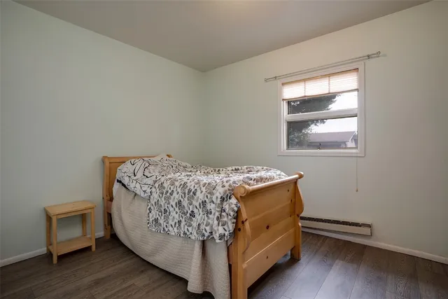 a living room with a bed and a window