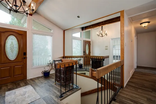 a view of a hallway with seating area and chandelier