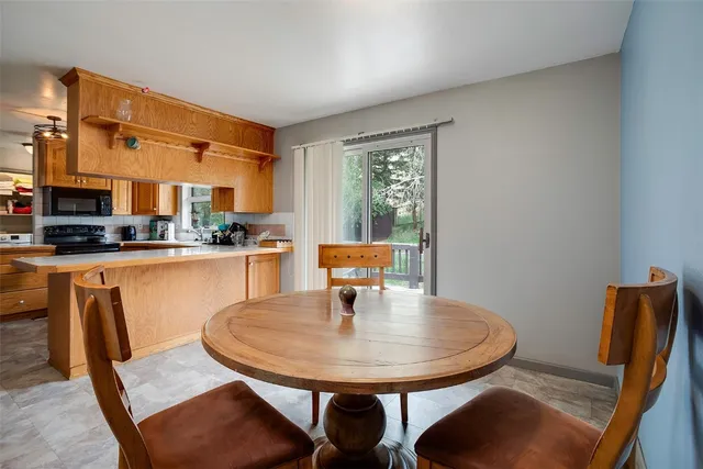a dining room with furniture and wooden floor