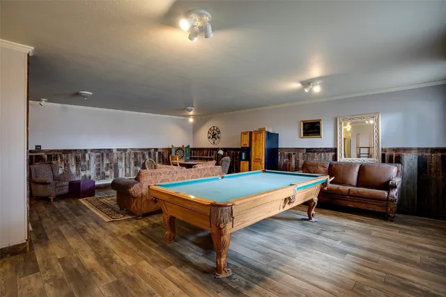 a living room with furniture pool and flat screen tv