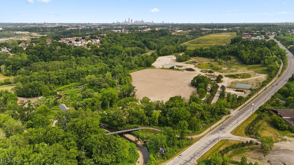 5000 Warner Road Garfield Heights, OH 44125 - Photo 22 of 41 Aerial view of property and surrounding area with a tree filled landscape