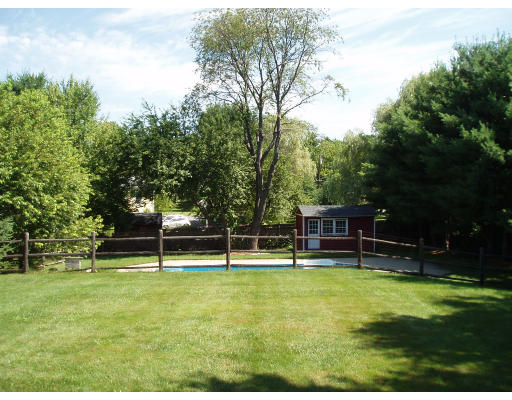 22 Warren Road Sudbury, MA 01776 - Photo 3 of 9 a swimming pool with trees in the background