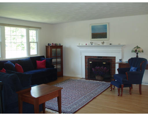 22 Warren Road Sudbury, MA 01776 - Photo 5 of 9 a living room with furniture and a fireplace